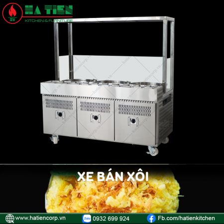Xe bán xôi inox có mái kính, dãy khay tròn giữ nóng trên mặt, ba cánh tủ dưới và bánh xe